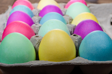 Fototapeta na wymiar Egg carton of colorful dyed Easter eggs