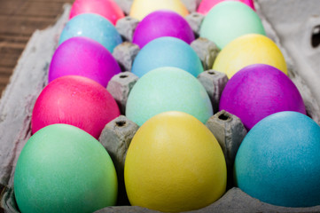 Egg carton of colorful dyed Easter eggs