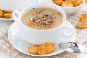 mushroom soup puree with croutons in white bowl