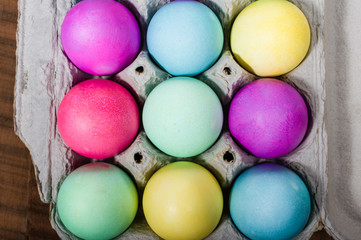 Egg carton of colorful dyed Easter eggs