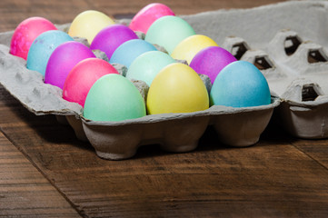 Egg carton of colorful dyed Easter eggs