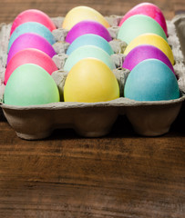 Egg carton of colorful dyed Easter eggs