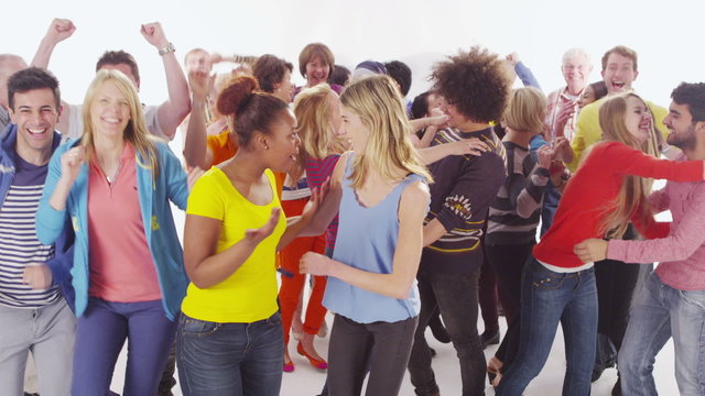 Happy diverse casual group jumping for joy on white background in studio shot