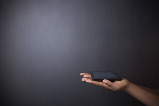 African or African American holding tablet