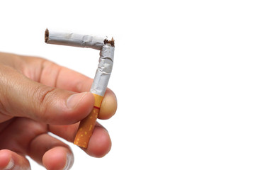 male hand destroying cigarettes - stop smoking concept