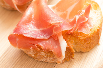 Tapas with jamon on grilled toast closeup