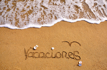 Vacations sign on the beach