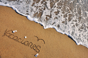 Vacations sign on the beach