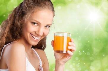 Juice. Young attractive happy woman with glass of juice