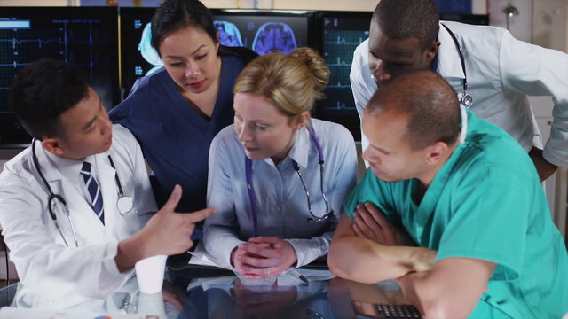 Group of colleagues in a medical meeting discuss a patient's x ray results