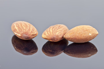 roasted almonds are on the reflecting surface