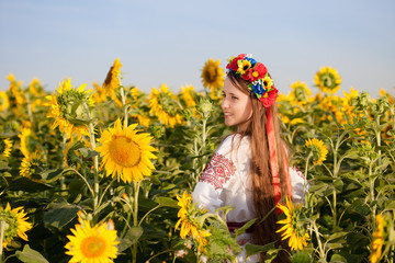 Beautiful young girl at sunflower field