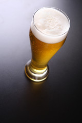 Tall glass of light beer