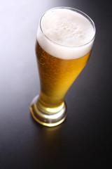 Tall glass of light beer