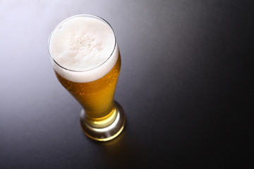 Tall glass of light beer