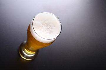 Tall glass of light beer