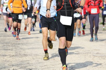 adult athletes run in the outdoor race on the road