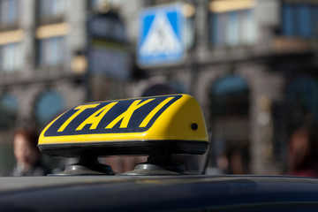 taxi cap on a car roof