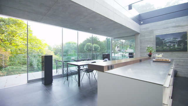 Interior view of kitchen dining area in contemporary home with natural view