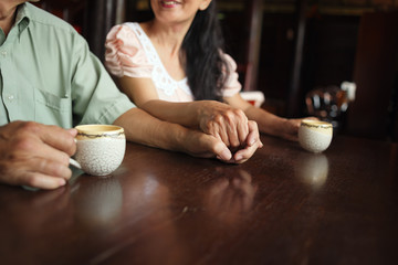 Tea cups and holding hands