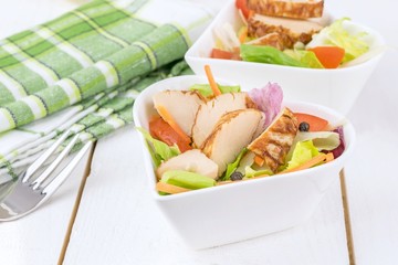 A fresh chicken salad in a heart shaped bowl