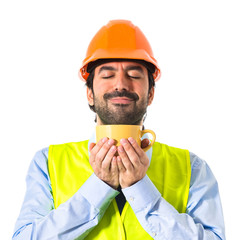 Workman holding a cup of coffee