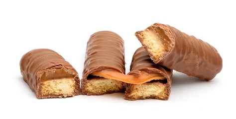 Chocolate bars with caramel and cookie on a white background.