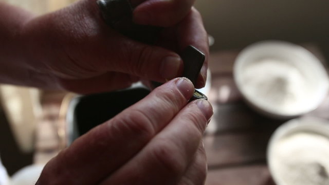 caucasian woman hands oils knives in container of baking machine
