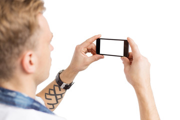 Young man taking photo with mobile phone