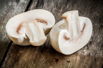 raw champignons on a rustic table close up