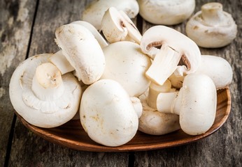 raw fresh champignons in  the bowl close up