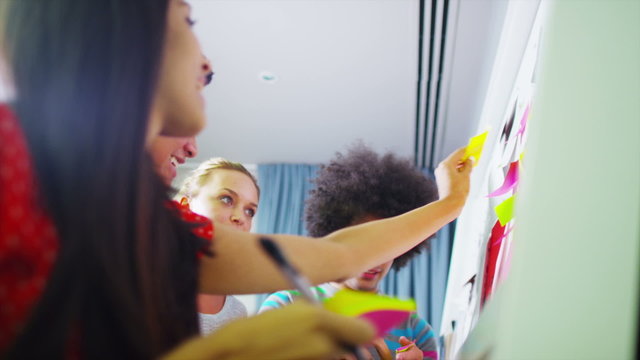 Young creative business team brainstorming with the use of post-it notes