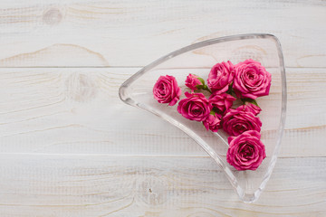 Pink roses in glass plate