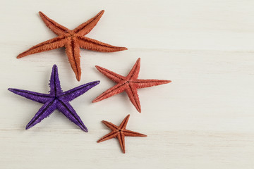 Fototapeta na wymiar colorful starfishes on woken surface