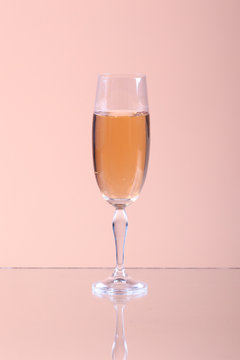 Glass of champagne on a beige background