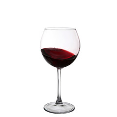 red wine swirling in a goblet wine glass, isolated on a white ba