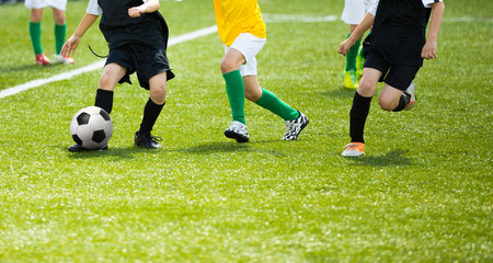 Boys playing football soccer match