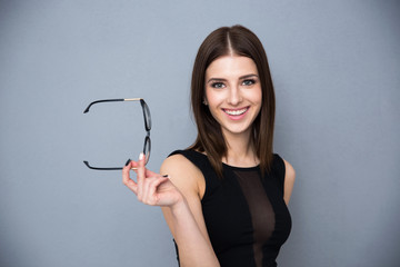 Happy beautiful woman holding glasses