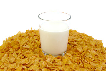 Glass of milk and corn flake cereals on a white background