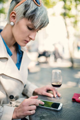 Young woman using smartphone in a cafe in Paris, France. Shallow