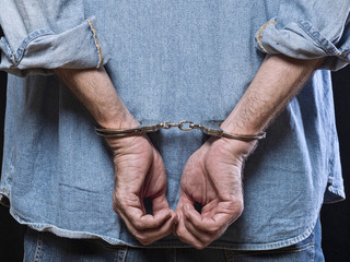 Man in handcuffs behind his back