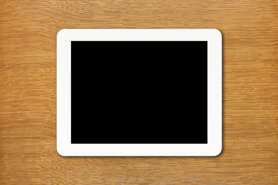 White Tablet PC With Black Screen On The Table