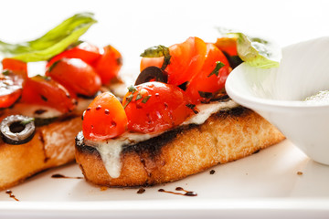 Bruschetta with tomato, mozarella and basil