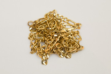 Gold necklace in pile