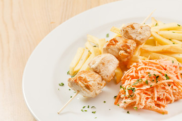 Chicken skewers with french fries