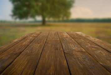 Wooden table outdoors with autumn field background