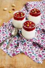 Homemade dessert - yogurt with mashed raspberry and pistachio