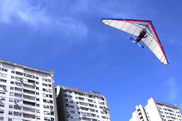 Hang glider over buildings