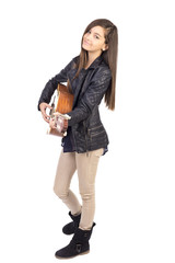Beautiful teenage girl playing guitar and singing