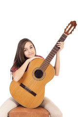 Fototapeta premium Portrait of pretty teenage girl and her guitar